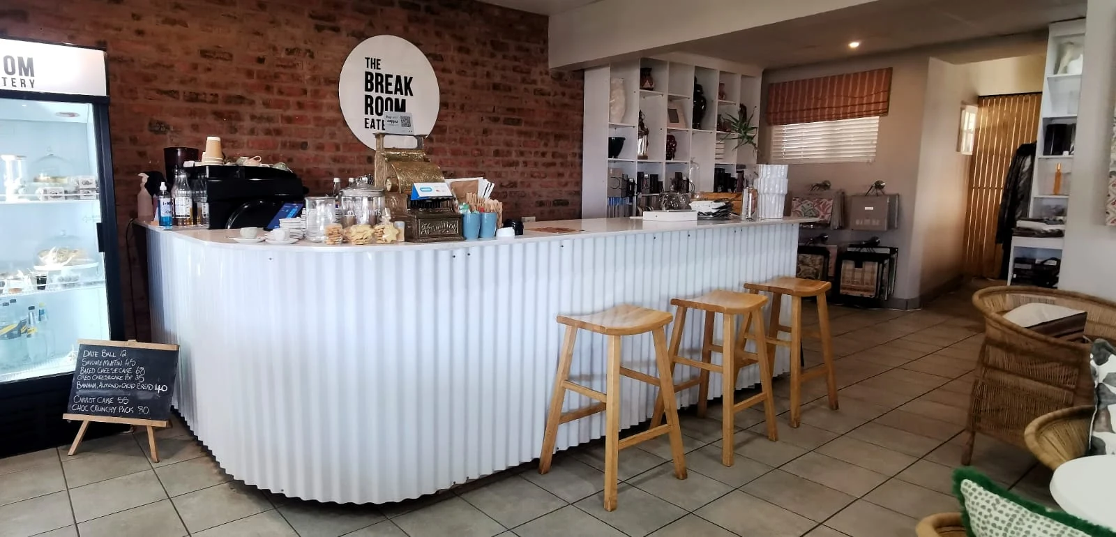 The counter at The Break Room with the cake cabinet and coffee machine